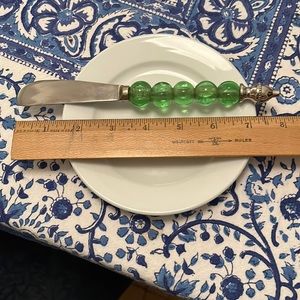 Decorative cheese knife with green glass beads
